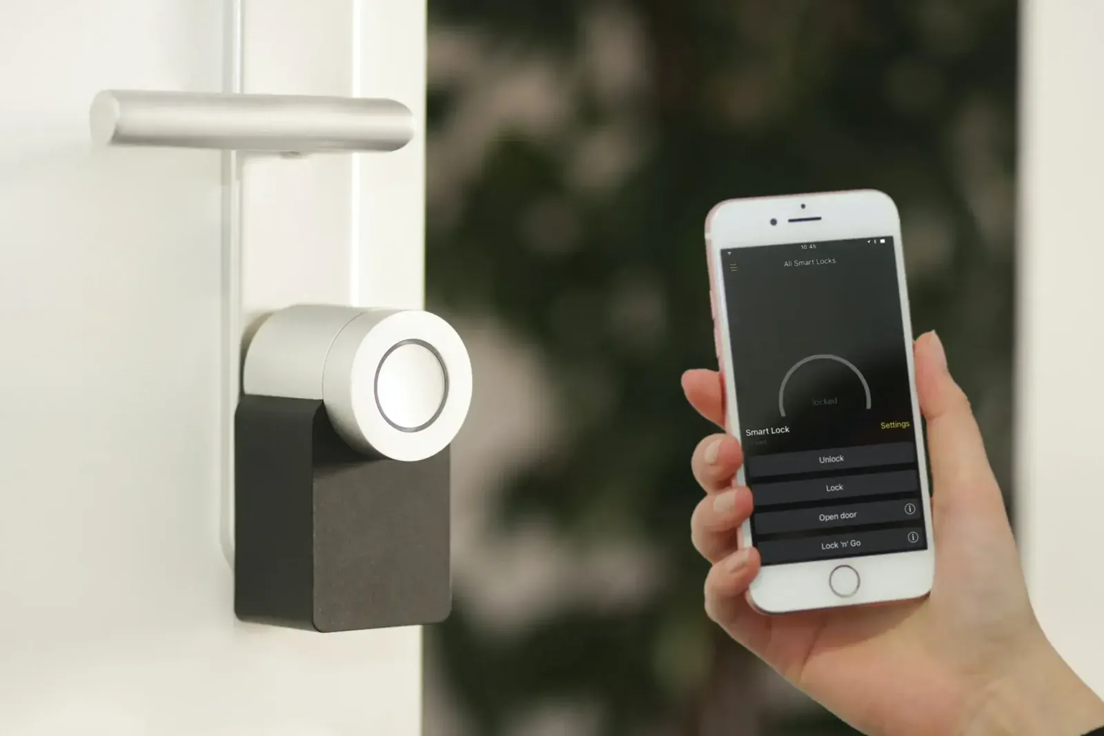 Person unlocking a smart door lock with a smartphone app