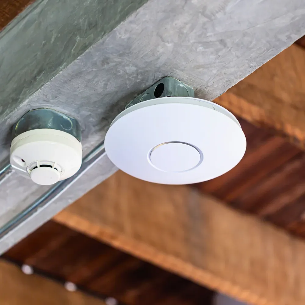 Ceiling access point installed next to a smoke detector