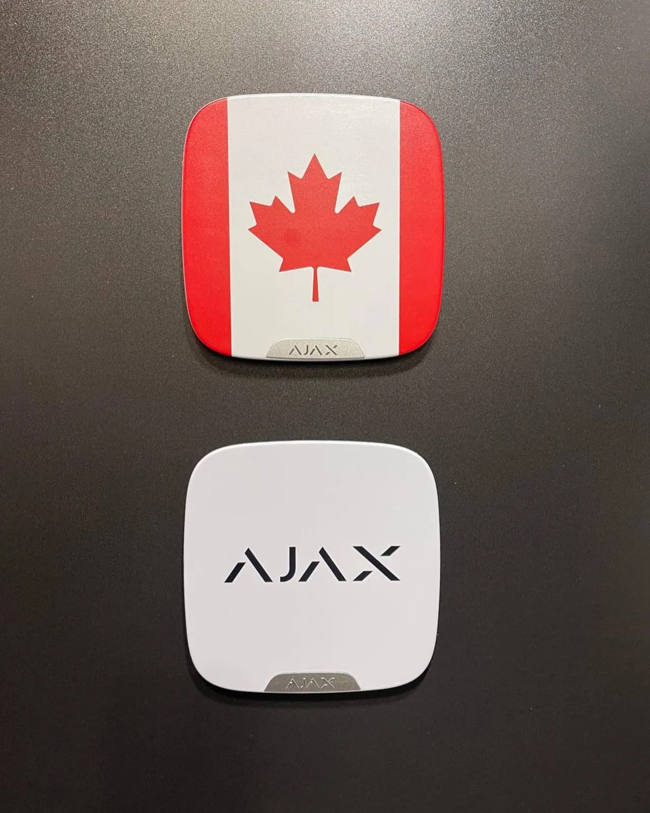Ajax Systems hubs, one with a Canadian flag design