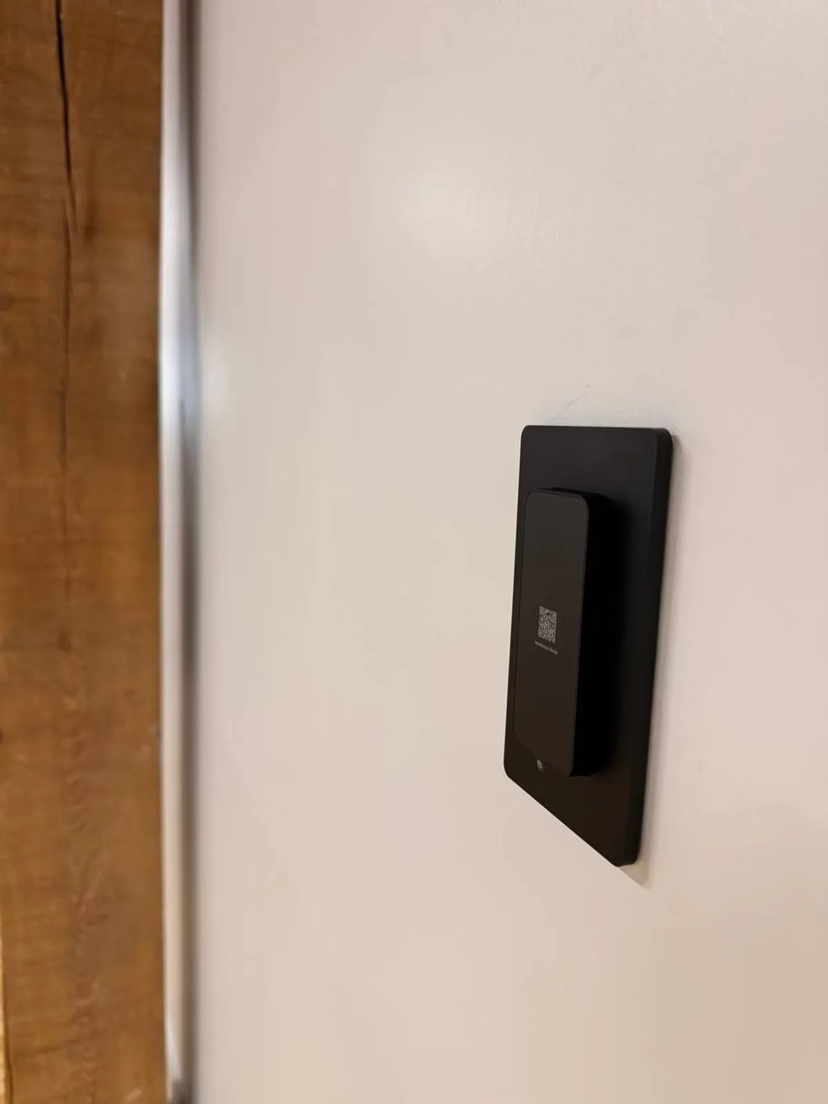 Black UniFi Access card reader mounted on a door frame at a Toronto studio