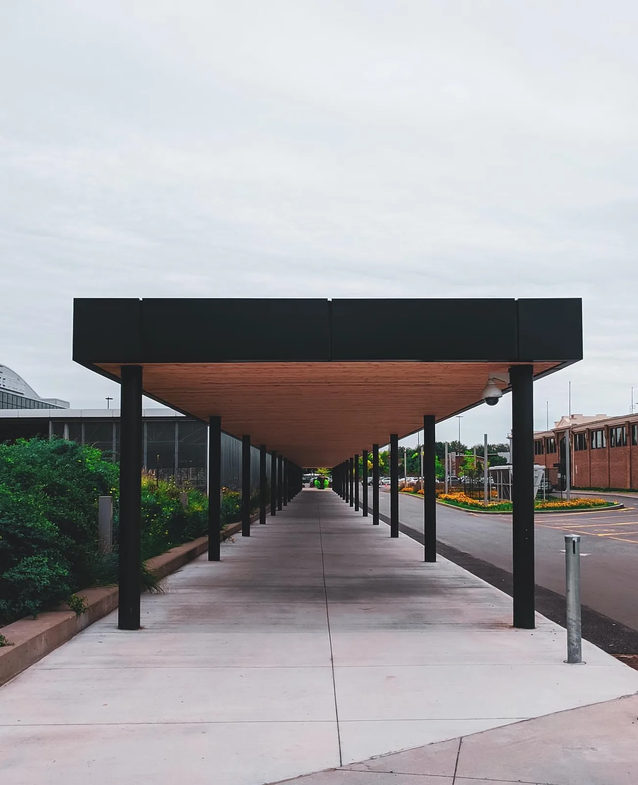 Cameras mounted along a long covered walkway canopy