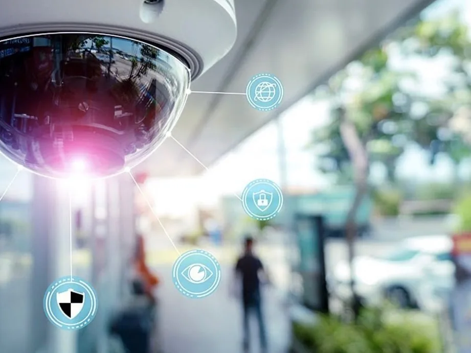 Dome camera with network icon overlay in a lobby