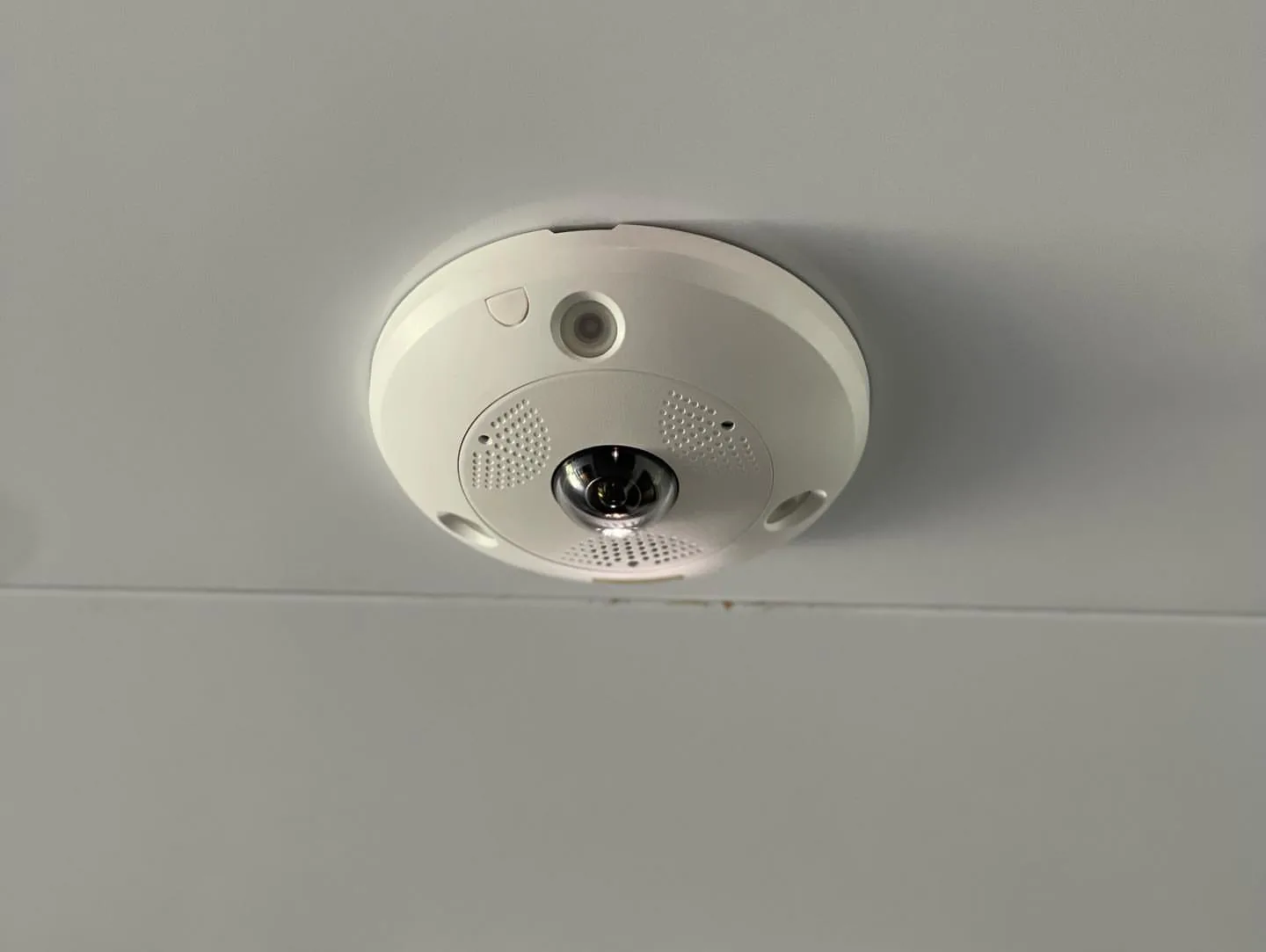 Close-up of a 360-degree fisheye camera on a ceiling