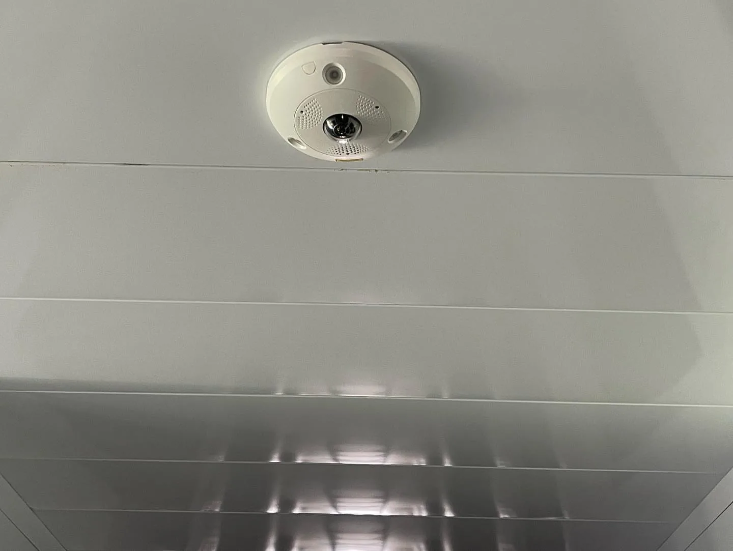 360-degree fisheye camera on a white ceiling