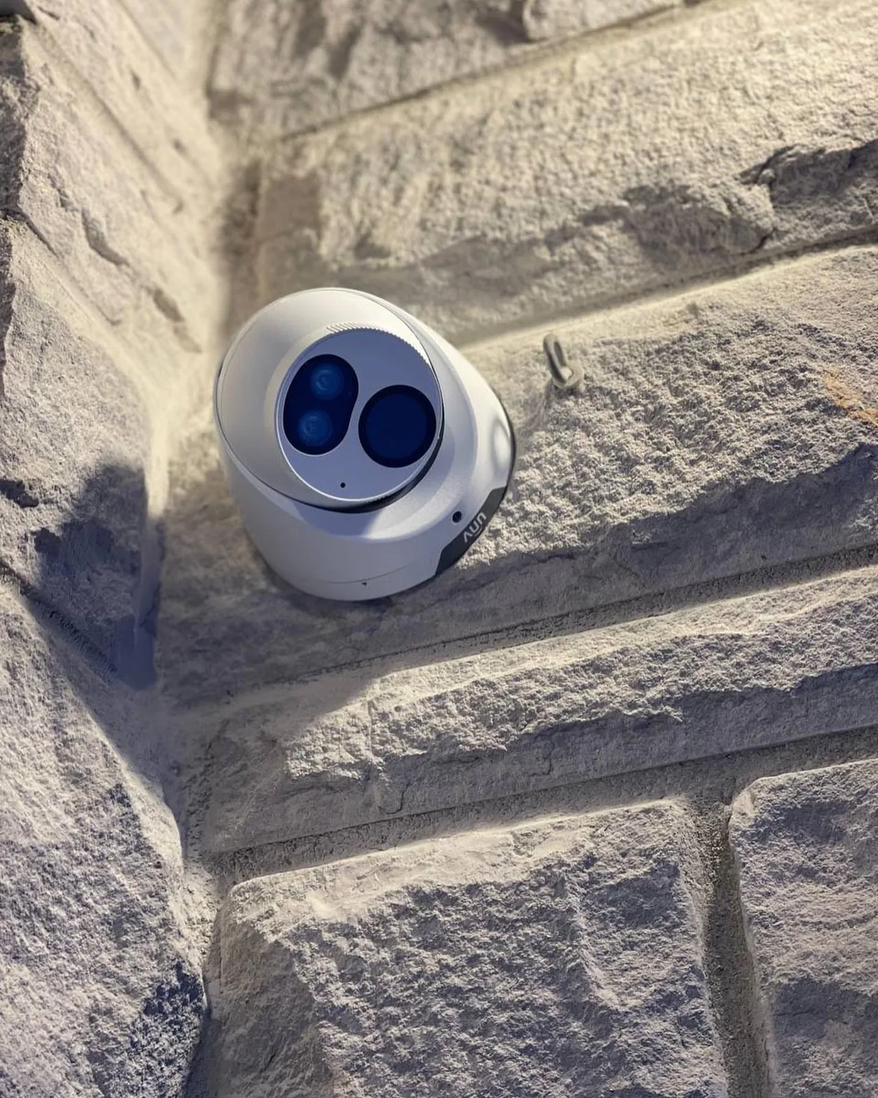 Turret camera on a white stone wall