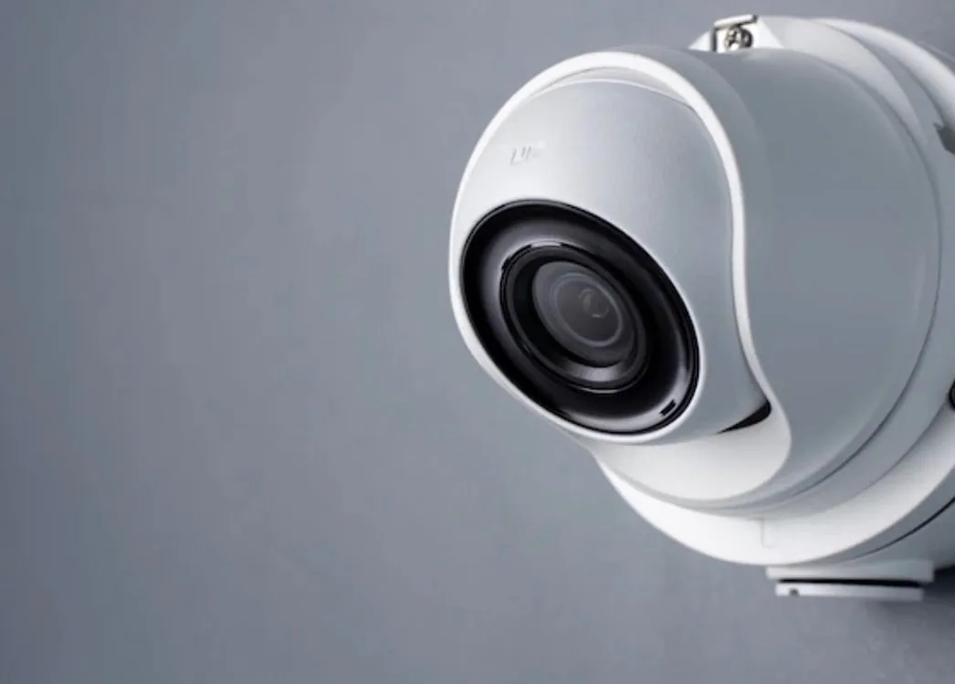 White dome camera on a grey background