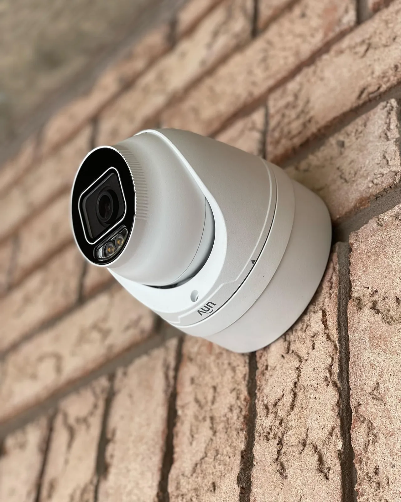 White turret camera on a brick wall in Mississauga