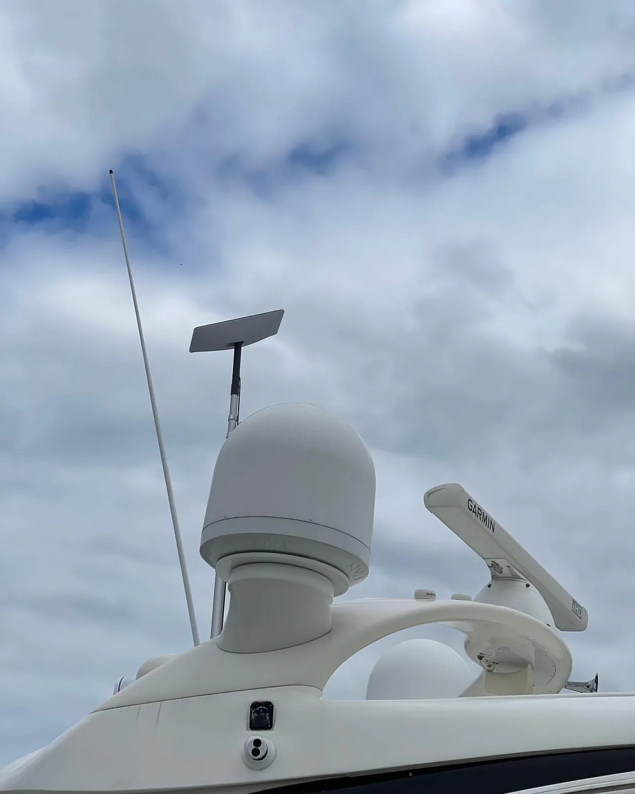 Starlink dish mounted on a boat radar arch under a dramatic sky