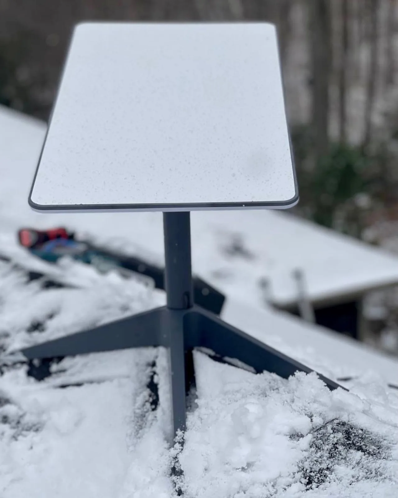 Starlink dish on a snow-covered roof