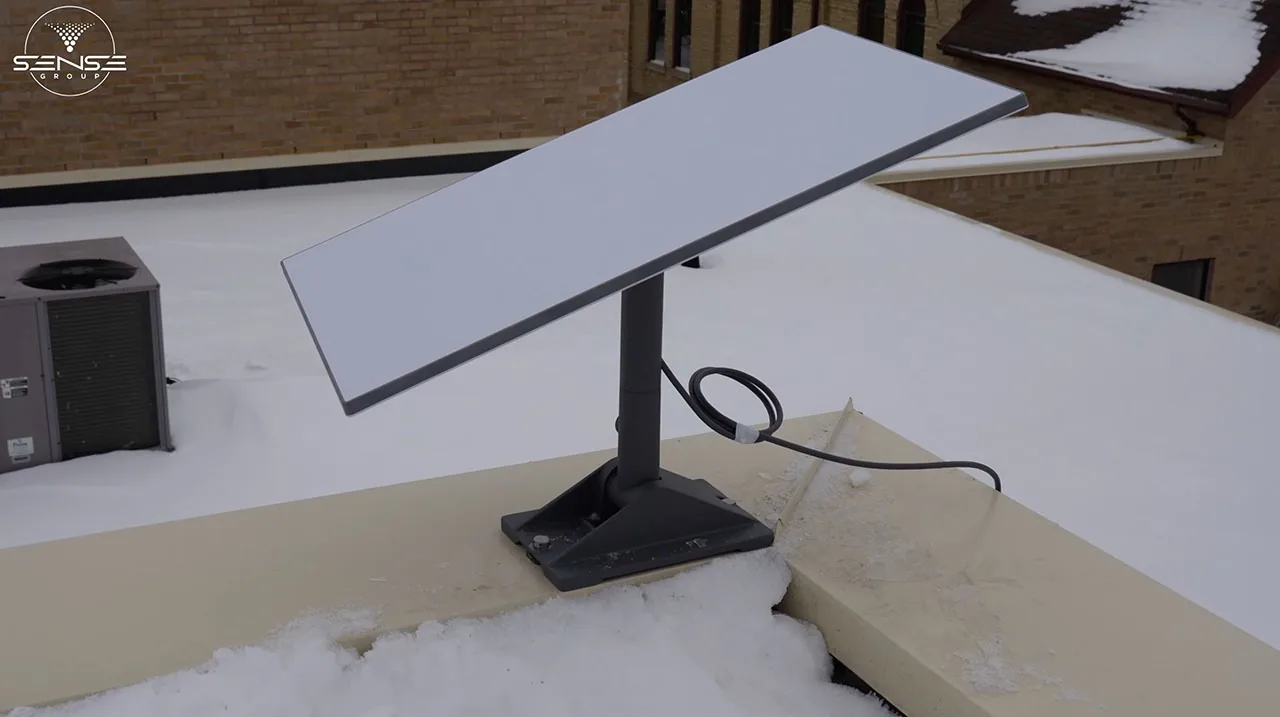 Starlink dish mounted on the church roof in snow