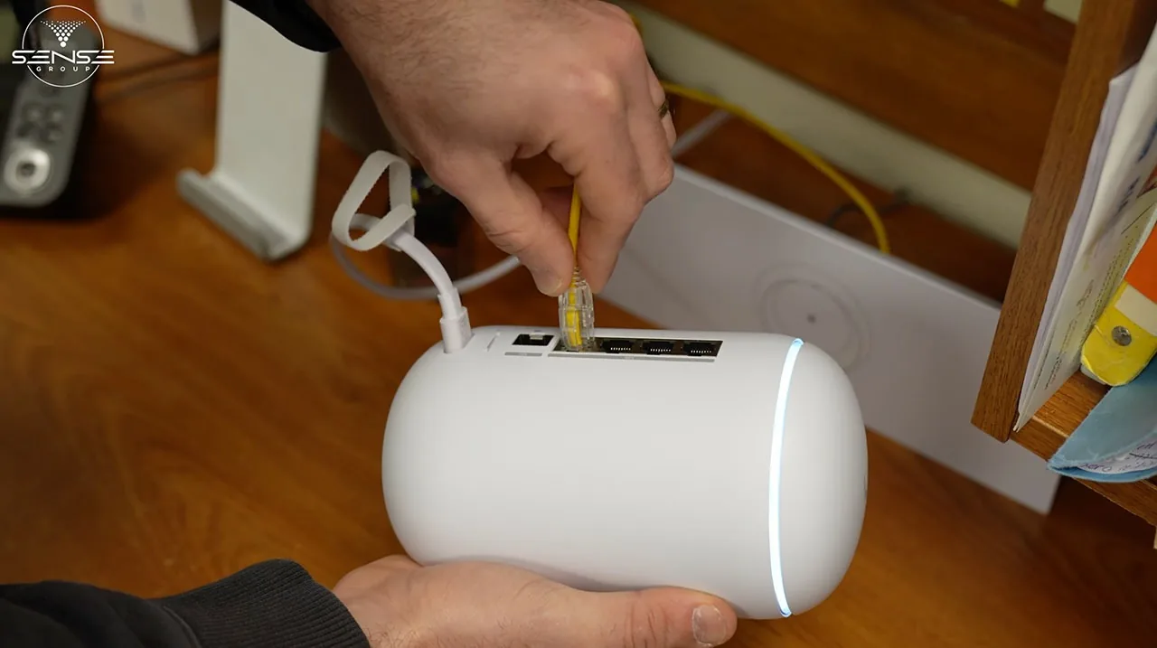 Technician wiring a UniFi access point