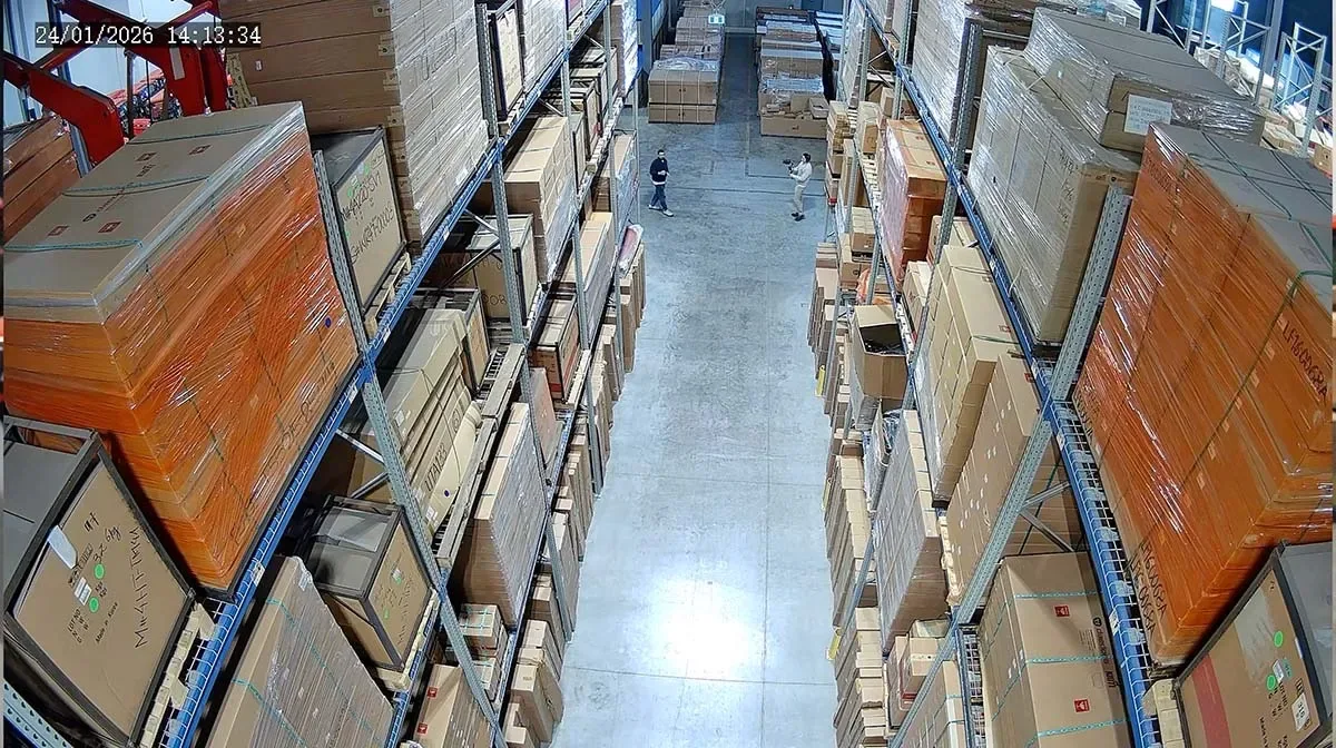 Overhead camera view of a warehouse aisle with racking