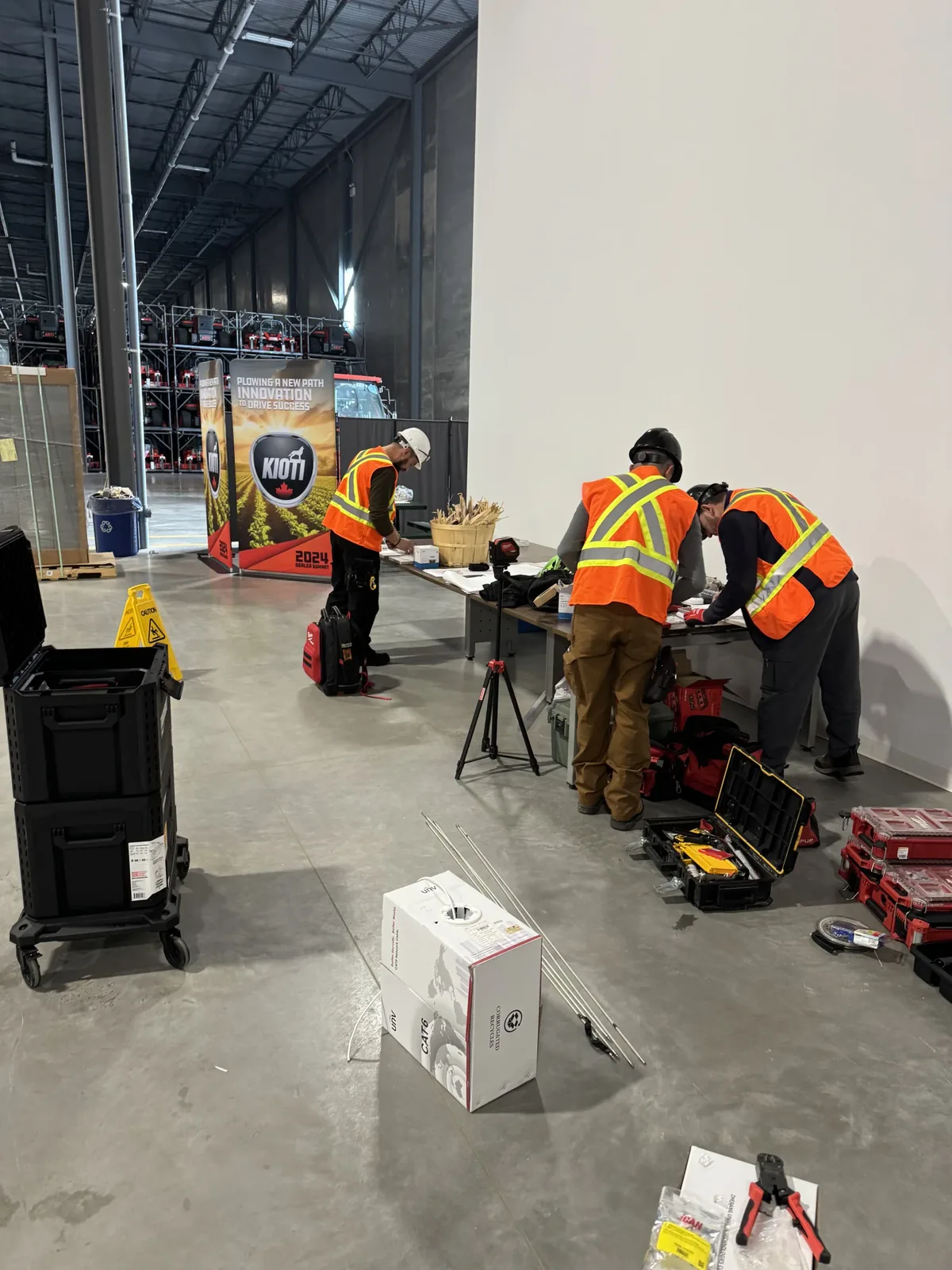 Sense Group crew in high-visibility vests working on the warehouse floor