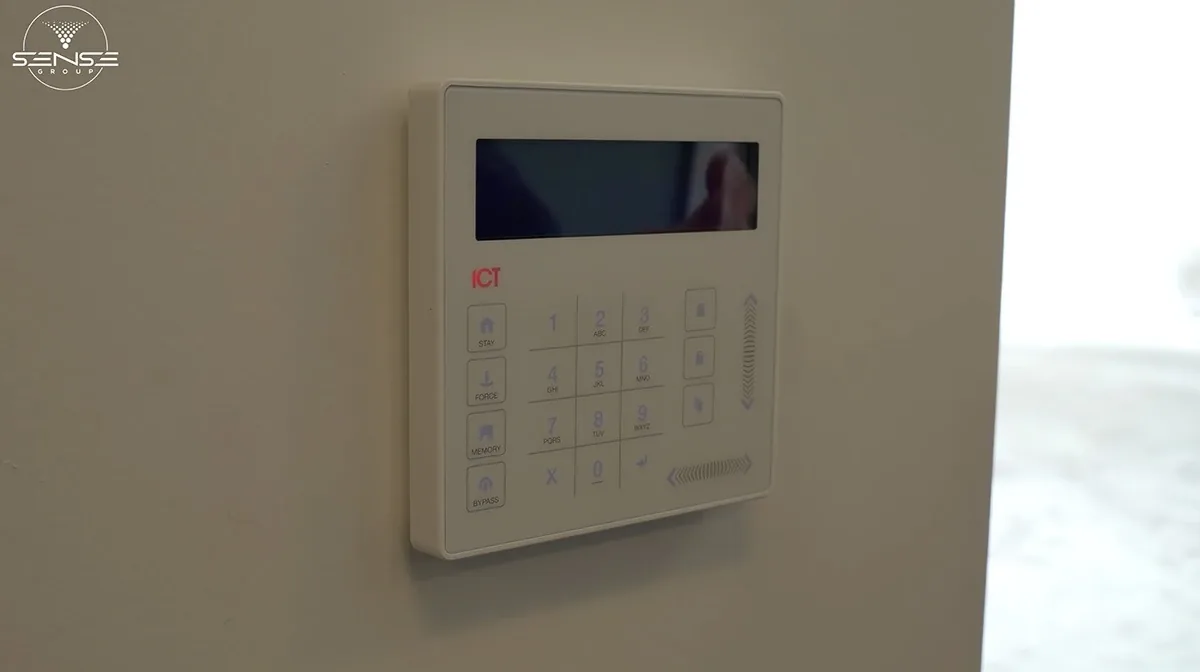 White ICT alarm keypad on an interior wall