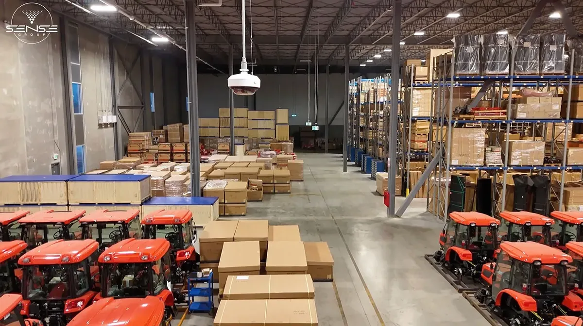 High-ceiling warehouse interior with racking and tractors